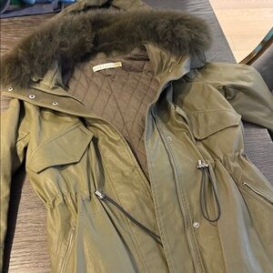 Alice and Olivia olive green parka coat with a fox fur-trimmed hood.